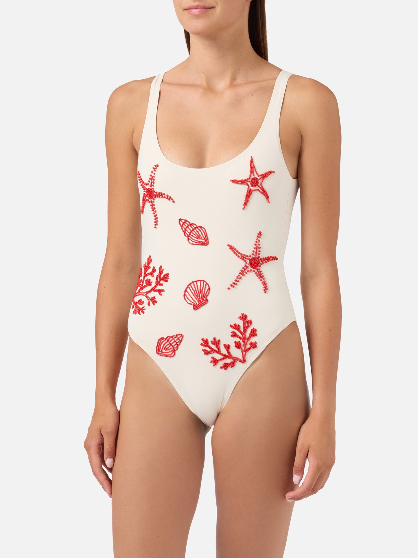 Lora one-piece swimsuit in cream with beaded sea-themed decorations
