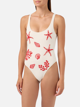 Lora one-piece swimsuit in cream with beaded sea-themed decorations